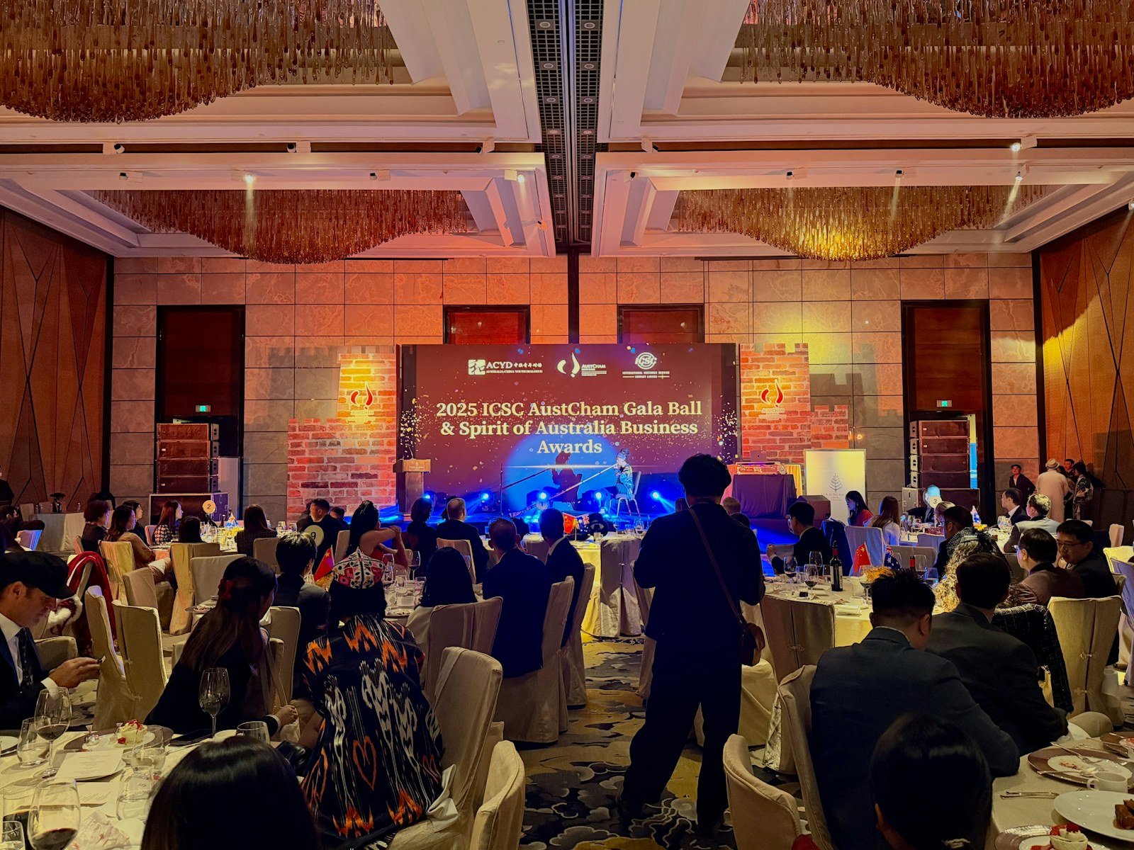 Corporate gala with a presentation stage and seated guests
